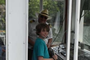 Captain Gus with a curious passenger aboard the Lake Queen