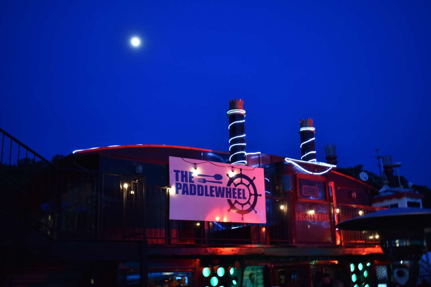 A beautiful moon floats over The Paddlewheel